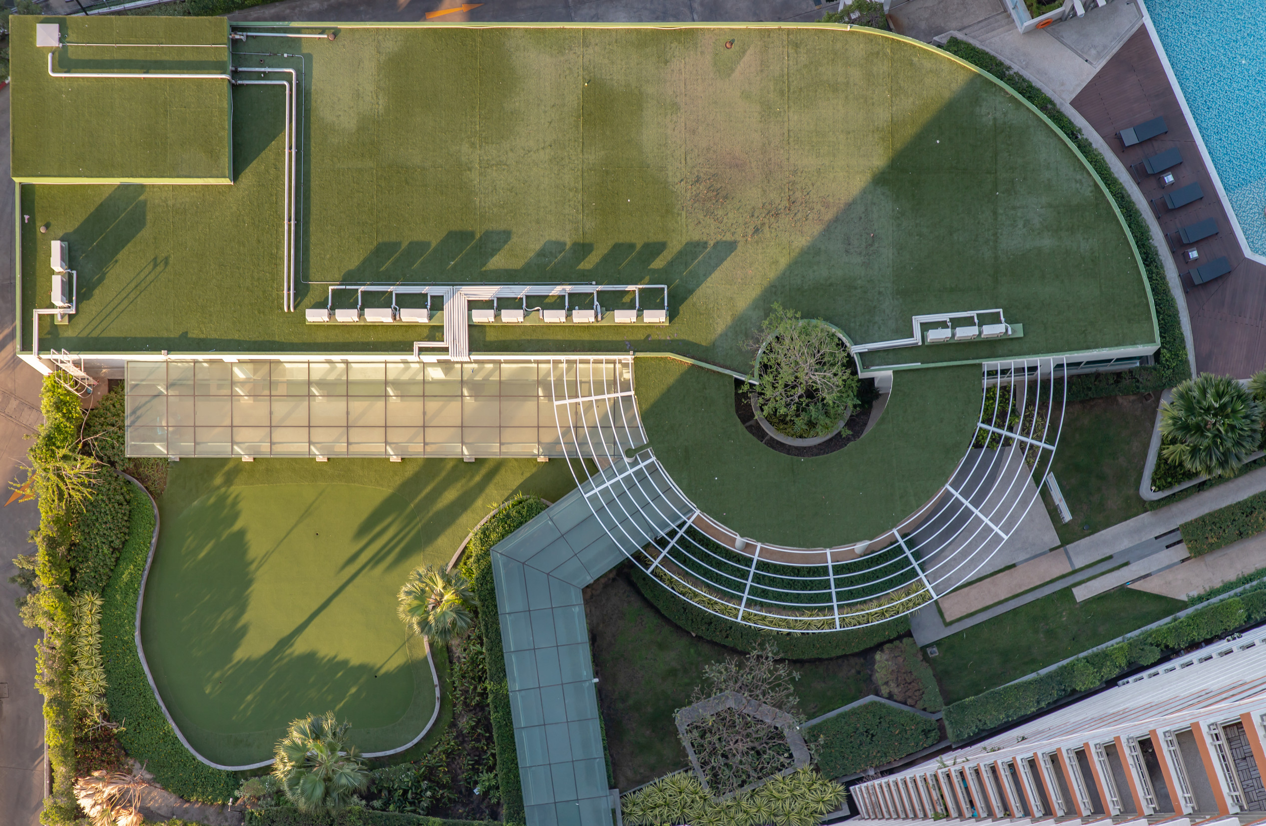 Top down aerial view of outdoor Green garden and Golf Driving Ra commercial artificial turf installation at a Tucson business property